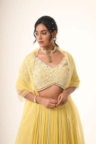Yellow floral cutwork blouse with lehenga