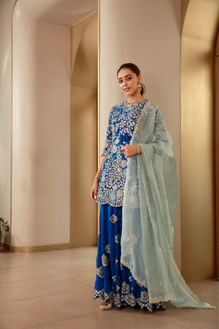 Three-quarter view of the jade blue rasm sharara with fan-shaped medallion motifs by Osaa by Adarsh at Mrs. G