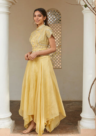 Three-quarter view of taupe lemon scalloped peplum top and asymmetrical skirt by Osaa by Adarsh at Mrs. G