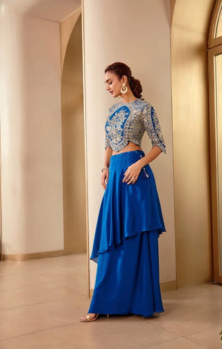 Side view of jade blue layered asymmetrical skirt and scalloped embroidered top by Osaa by Adarsh at Mrs. G