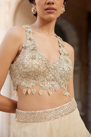 Close-up of beige champagne halter top with 3D flower straps and teardrop tassels by Osaa by Adarsh at Mrs. G