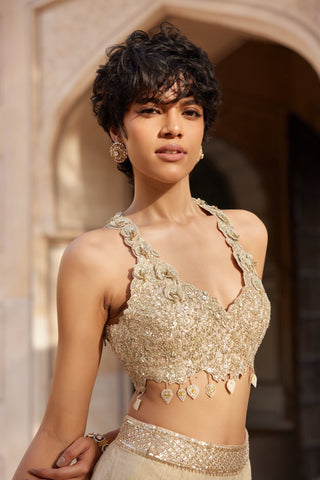 Portrait of beige champagne halter top with sequin embroidery and embroidered skirt waistband by Osaa by Adarsh at Mrs. G