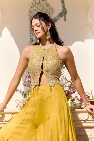 Waist-up view of canary yellow halter top with keyhole opening and zardozi appliqué by Osaa by Adarsh at Mrs. G