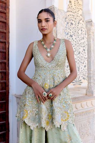 Waist-up view of sage peplum top with gold zardozi and yellow appliqué flowers by Osaa by Adarsh at Mrs. G