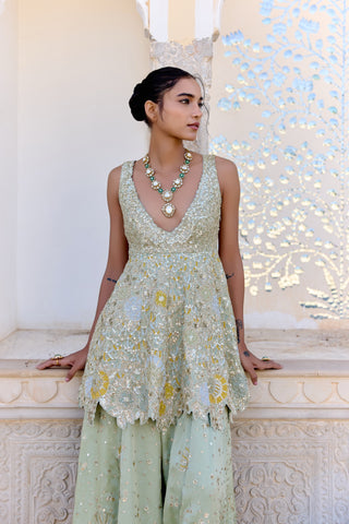 Close view of sage peplum top with gold zardozi, scalloped hem and sequinned garara by Osaa by Adarsh at Mrs. G