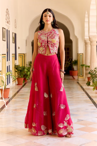 Front view of cut ruby sleeveless embroidered top and wide sharara with gold shell motifs by Osaa by Adarsh at Mrs. G