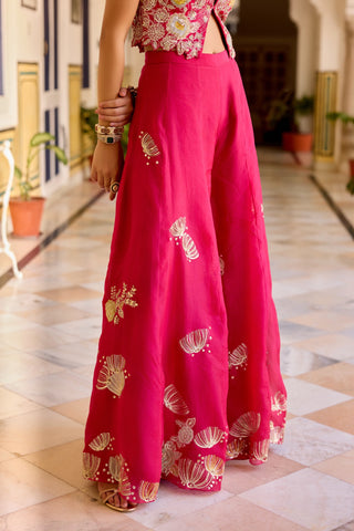 Close view of cut ruby wide sharara leg with scattered gold and ivory shell motifs by Osaa by Adarsh at Mrs. G