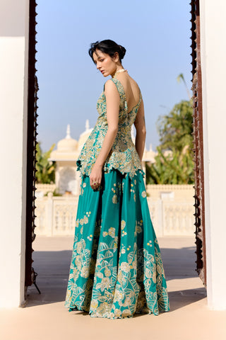 Back view of pine green peplum top with a low scooped back and a floral embroidered garara by Osaa by Adarsh at Mrs. G