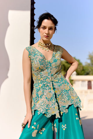 Waist-up view of pine green V-neck peplum top with button front and yellow appliqué blooms by Osaa by Adarsh at Mrs. G