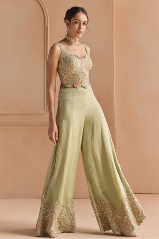 Three-quarter view of sage top and garara with embroidered scalloped borders at the hem by Osaa by Adarsh at Mrs. G