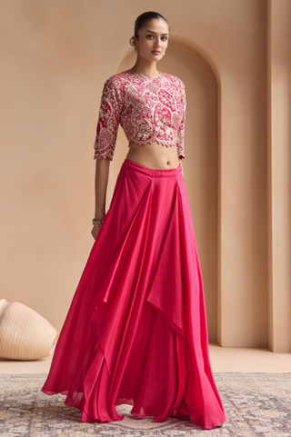 Three-quarter view of scarlet top and asymmetric draped flared skirt by Osaa by Adarsh at Mrs. G