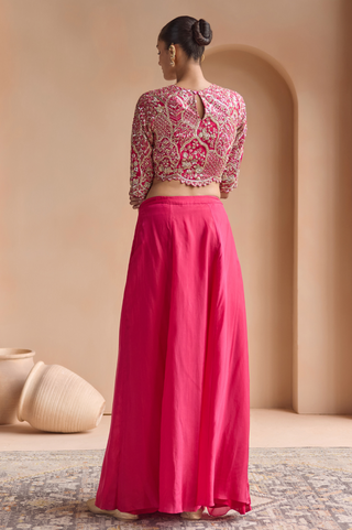 Back view of scarlet top with keyhole back and gold embroidery over a flared skirt by Osaa by Adarsh at Mrs. G