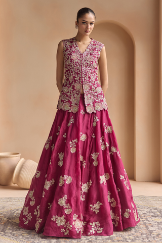 Front view of sangria plum sleeveless V-neck jacket with floral embroidery over a flared A-line lehenga by Osaa by Adarsh at Mrs. G