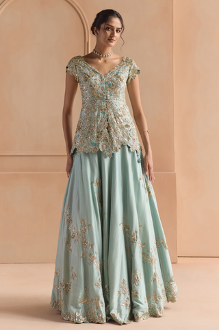 Front view of teal peplum jacket with V-neckline and flared A-line lehenga with gold floral embroidery by Osaa by Adarsh at Mrs. G