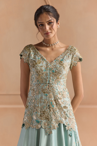 Close-up of teal peplum jacket with cap sleeves, scalloped hem and gold zardozi flowers by Osaa by Adarsh at Mrs. G