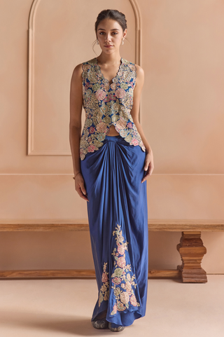 Front view of midnight blue sleeveless V-neck jacket with multicolor flower applique over a draped skirt by Osaa by Adarsh at Mrs. G