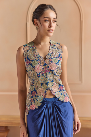 Waist-up view of midnight blue jacket with scalloped V-neckline and pink, green and gold flowers by Osaa by Adarsh at Mrs. G