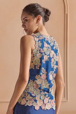 Close-up back of midnight blue jacket with scalloped hem and pink and gold flower applique by Osaa by Adarsh at Mrs. G