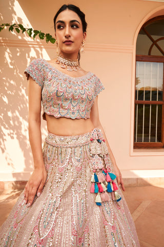 Portrait of soft berry scalloped cap-sleeve blouse and lehenga waistband with tassel latkan by Osaa by Adarsh at Mrs. G