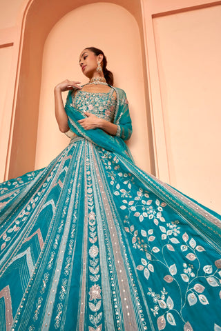 Twirling view of pine green lehenga skirt with leaf creeper and chevron embroidery by Osaa by Adarsh at Mrs. G