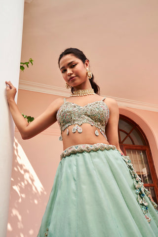 Close-up of cadet blue bralette with floral embroidery and teardrop tassels by Osaa by Adarsh at Mrs. G