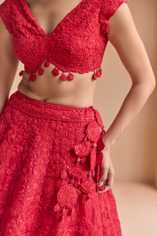 Close-up of rosewood red blouse tassel hem and skirt waistband with rosette tassels by Osaa by Adarsh at Mrs. G