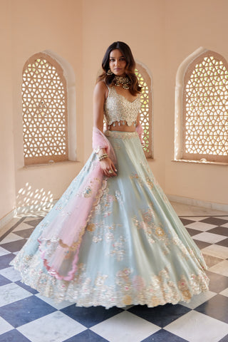Twirling view of tea green flared lehenga with scalloped floral hem border by Osaa by Adarsh at Mrs. G