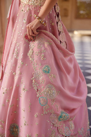 Close-up of flamingo pink lehenga with turquoise and pink applique flowers at the hem by Osaa by Adarsh at Mrs. G