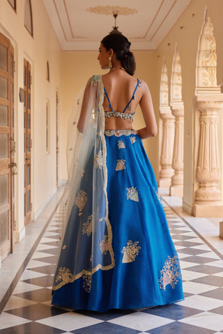 Back view of blueberry lehenga with strappy bralette and net dupatta by Osaa by Adarsh at Mrs. G