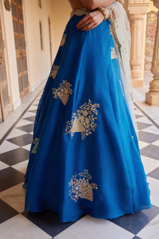 Close-up of blueberry lehenga skirt with gold basket-of-flowers motifs by Osaa by Adarsh at Mrs. G
