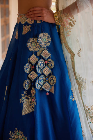 Close-up of blueberry lehenga waist with medallion latkan and gold zardozi motifs by Osaa by Adarsh at Mrs. G