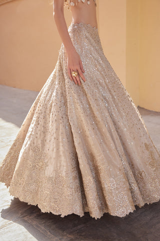 Close-up of beige champagne sequin-scattered lehenga skirt with scalloped waistband by Osaa by Adarsh at Mrs. G