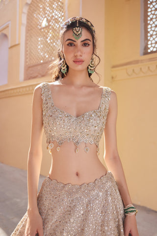 Close-up of beige champagne sweetheart blouse with teardrop tassels and scalloped waistband by Osaa by Adarsh at Mrs. G
