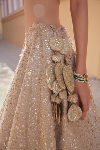 Side close-up of beige champagne leaf-shaped latkan on sequin lehenga by Osaa by Adarsh at Mrs. G