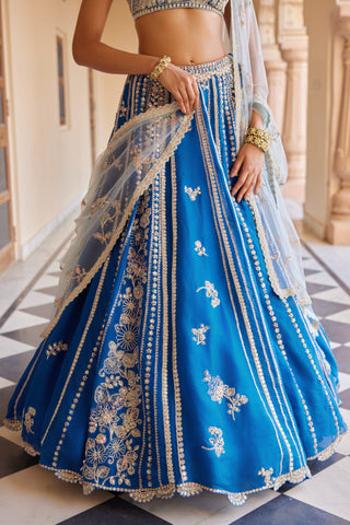 Close-up of jade blue lehenga skirt panels with gold zardozi lines and floral sprigs by Osaa by Adarsh at Mrs. G