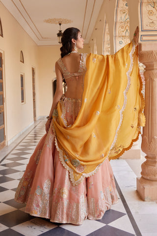 Back view of salmon peach lehenga with embroidered blouse and mustard organza dupatta by Osaa by Adarsh at Mrs. G