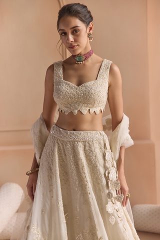 Waist-up view of ivory sweetheart blouse with scalloped hem and beaded embroidery by Osaa by Adarsh at Mrs. G