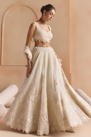 Twirl view of ivory flared lehenga with scalloped hem and sequin motif border by Osaa by Adarsh at Mrs. G