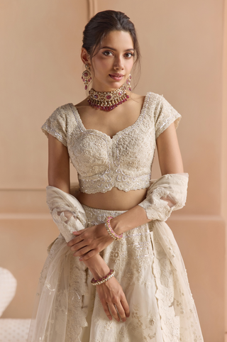 Waist-up view of ivory sweetheart blouse with cap sleeves and scalloped hem with a ruby choker by Osaa by Adarsh at Mrs. G