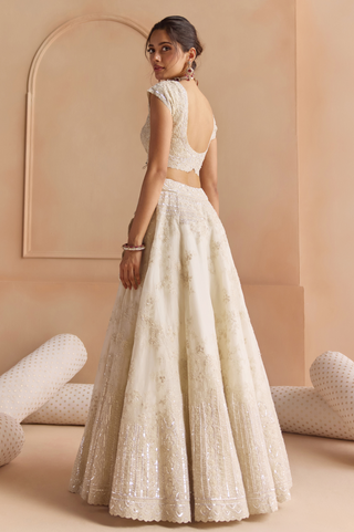 Back view of ivory cap sleeve blouse with deep scoop back and embroidered skirt with sequin border by Osaa by Adarsh at Mrs. G