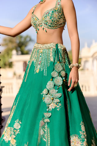 Close view of jewel green sweetheart blouse and waistband with disc flower cluster at the hip by Osaa by Adarsh at Mrs. G