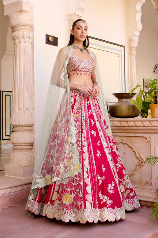 Front view of cut ruby lehenga with pale mint sequinned dupatta over the arms by Osaa by Adarsh at Mrs. G