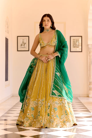 Front view of canary yellow lehenga with emerald dupatta and V-neck beaded blouse by Osaa by Adarsh at Mrs. G