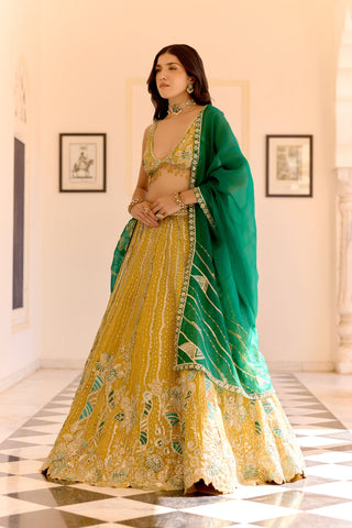 Front view of canary yellow lehenga with vertical zardozi lines and an emerald dupatta by Osaa by Adarsh at Mrs. G