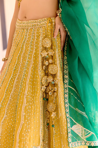Close view of canary yellow lehenga waistband with gold disc flowers and emerald dupatta by Osaa by Adarsh at Mrs. G
