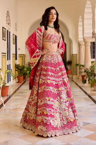 Three-quarter view of cut ruby lehenga with square-neck blouse and net dupatta over the arms by Osaa by Adarsh at Mrs. G