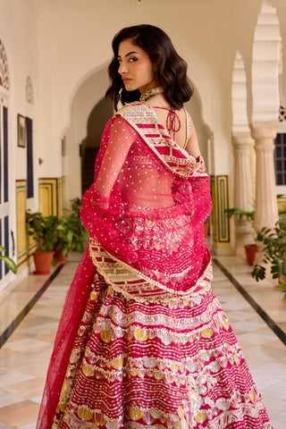 Back view of cut ruby lehenga with tie-back blouse and sequinned net dupatta by Osaa by Adarsh at Mrs. G
