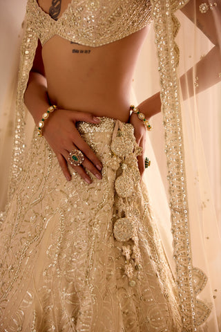 Close view of frost champagne lehenga waistband with fabric flower tassels and jaal embroidery by Osaa by Adarsh at Mrs. G