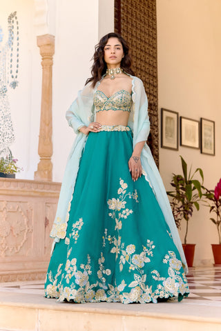 Front view of pine green lehenga with floral hem embroidery and pale aqua dupatta by Osaa by Adarsh at Mrs. G