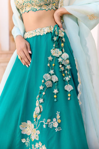 Close view of pine green lehenga waistband with tassel of fan and star ornaments by Osaa by Adarsh at Mrs. G